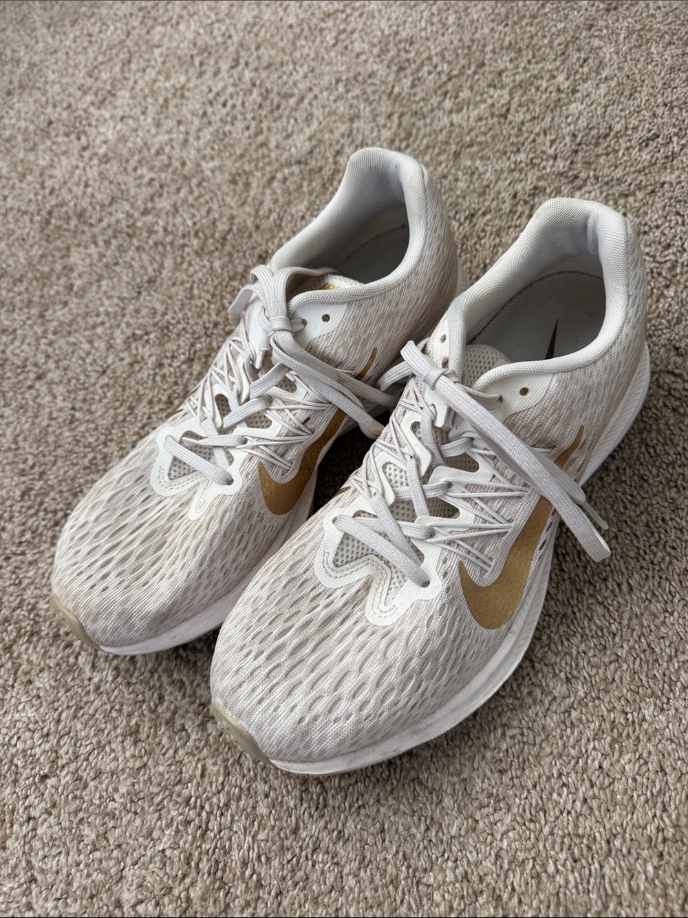 Nike Women's Off-White Running Sneakers with Gold Swoosh Accents